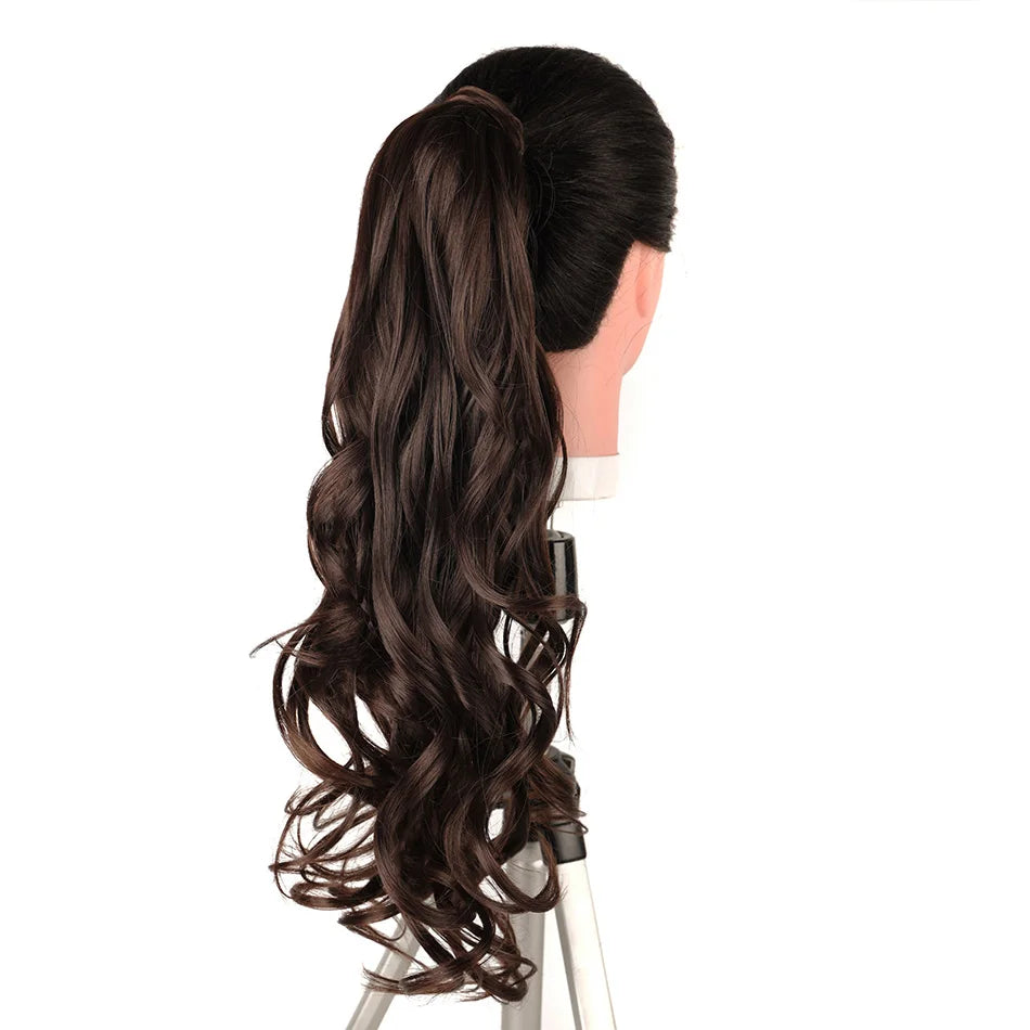 A dark brown, long, wavy hair extension styled in a high ponytail on a mannequin head.