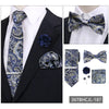 A set of men's formal tie and accessory featuring a blue and gold paisley pattern on a black suit jacket.