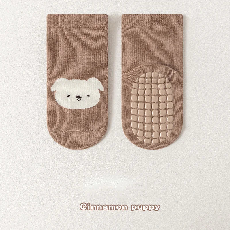 Pair of tan knitted socks featuring a white bear face design.