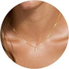 A close-up of a gold plated alphabet initial necklace with the letter J worn around the neck.