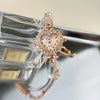 A sparkling heart-shaped rhinestone quartz watch is displayed on a clear plastic box.