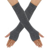 A pair of gray knitted fingerless gloves crossed on a person's hands.