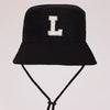 Black sun hat with a gold letter L embroidered on the front and an adjustable cord.