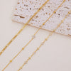 A set of delicate gold-toned crystal cross anklets displayed on a light background.