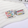 A set of colorful enamel lapel pins featuring text like Be the Reason Someone Smiles Today and a reminder message