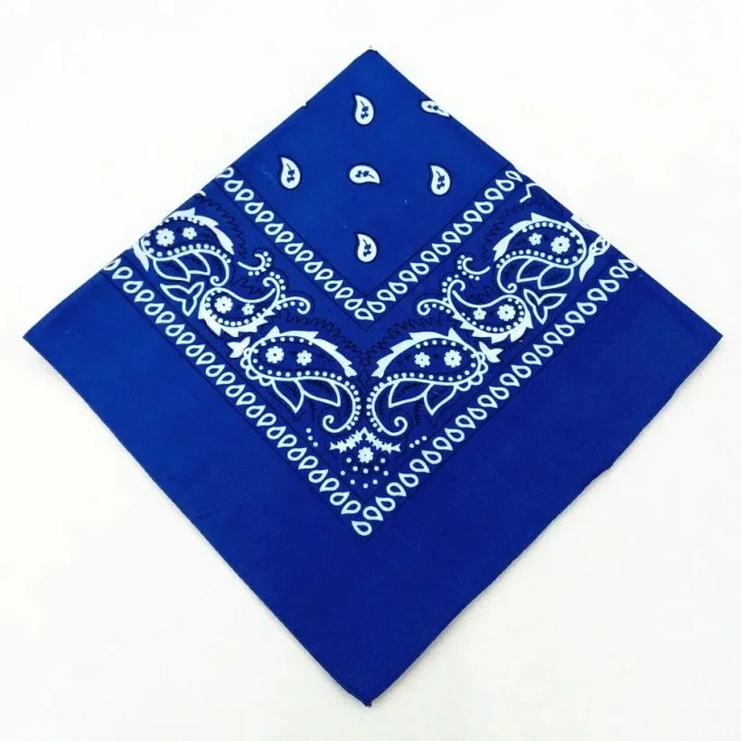 A royal blue cotton bandana scarf featuring white paisley and geometric patterns.