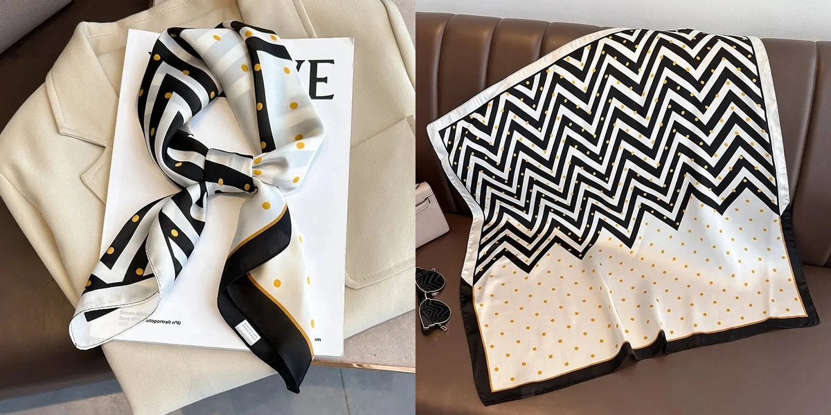 A black and white chevron patterned silk scarf draped on a white card against a beige background.