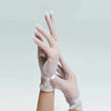 A close-up of sheer lace fishnet evening gloves worn on a hand.