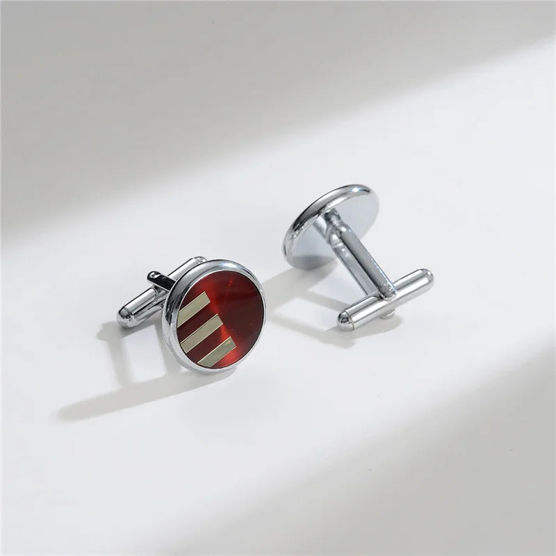 A pair of elegant copper cufflinks featuring a red and gold striped design.