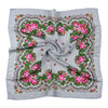 A gray scarf featuring a detailed floral print with pink and green roses and foliage.