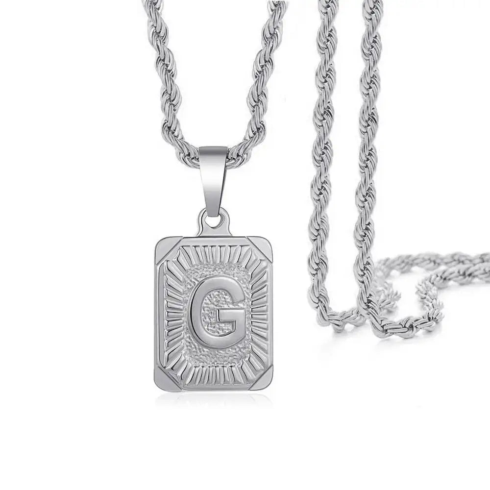 A silver letter pendant necklace featuring a gold-plated initial G on a silver chain.