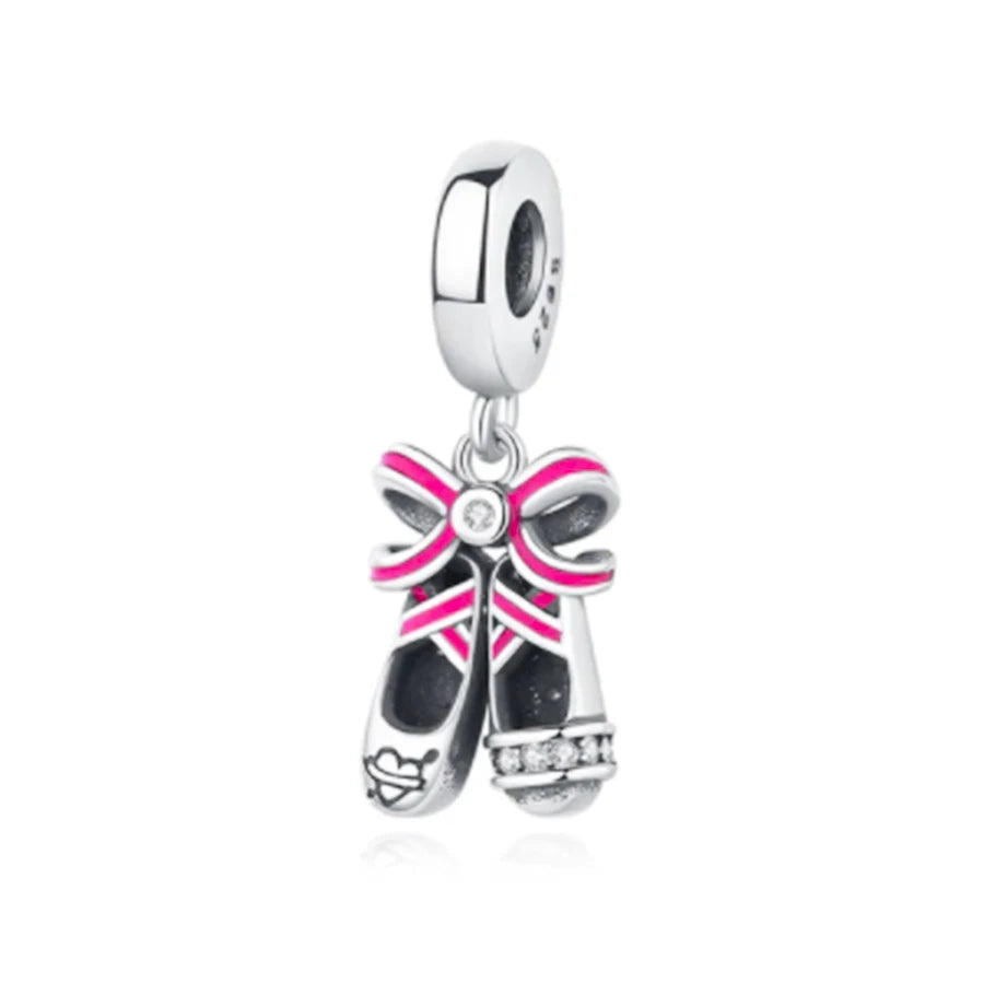 Pendientes de plata con diseño de lazo y acentos rosas y piedras brillantes.