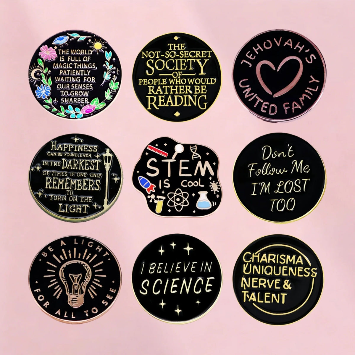 A collection of black lapel pins featuring inspirational quotes and symbols like a heart, a lightbulb, and text related to fa
