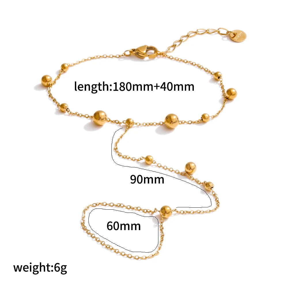 A delicate gold-plated bracelet featuring multiple spherical charms and a chain, with various length measurements shown.