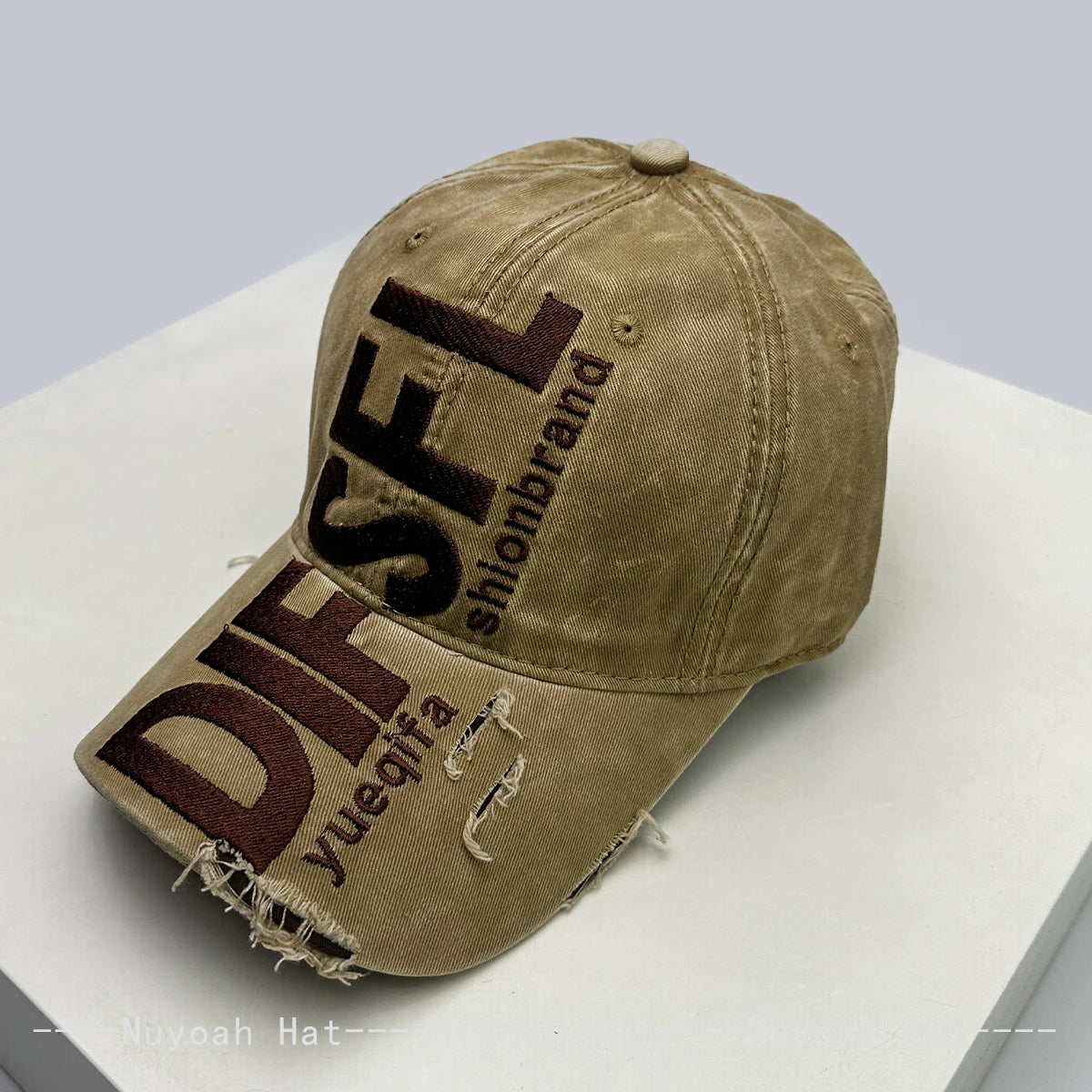 A tan baseball cap embroidered with the letters DFSL and the word shlonbrand