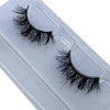 A pair of natural mink false eyelashes displayed on a clear plastic tray.