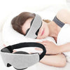 A person is sleeping while wearing a gray 3D contoured sleep mask for deep rest.