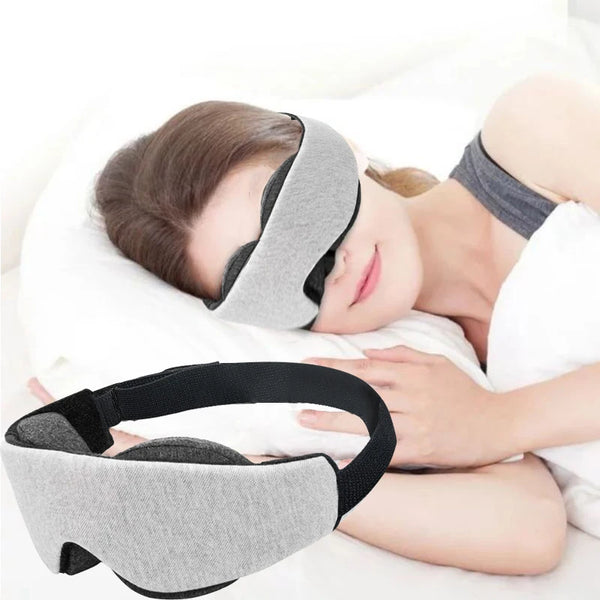 A person is sleeping while wearing a gray 3D contoured sleep mask for deep rest.