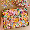 A tray filled with colorful decorative elastic hair bands and accessories for girls.