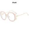 A pair of khaki-colored anti-blue light eyeglasses frames with thin gold-toned arms.
