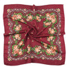 A deep red silk scarf featuring a detailed floral print with roses and greenery.