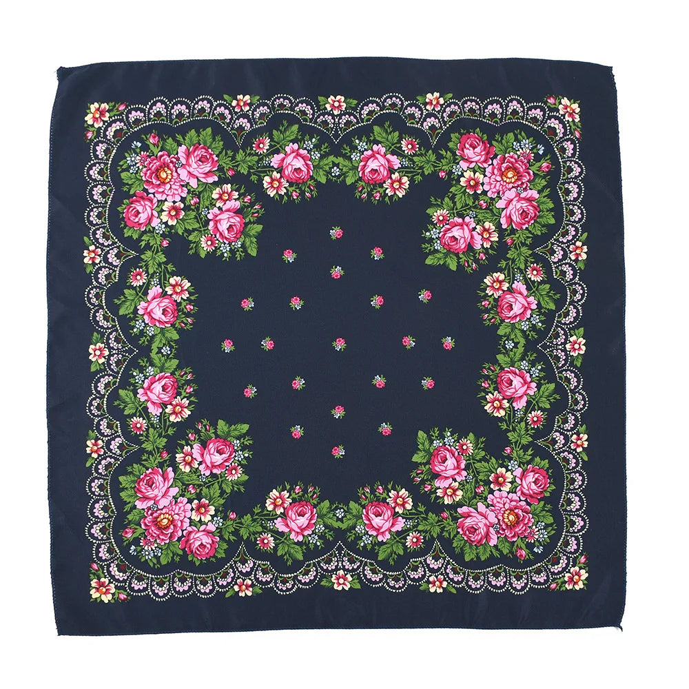 A dark blue square scarf featuring a detailed floral print with pink and green roses and foliage.