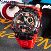 A close-up shot of a red digital wristwatch with black accents and a dark face, resting on a black surface.