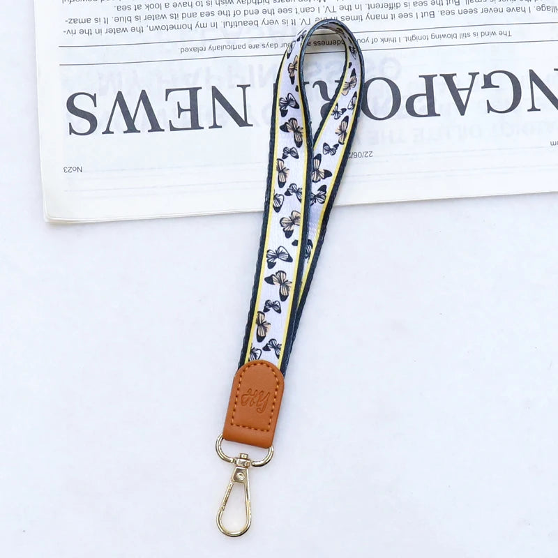 Brauner Leder-Handy-Lanyard mit gemustertem Stoffriemen und Metallverschluss