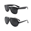 A pair of black vision correction pinhole glasses with a perforated lens and dark frame.