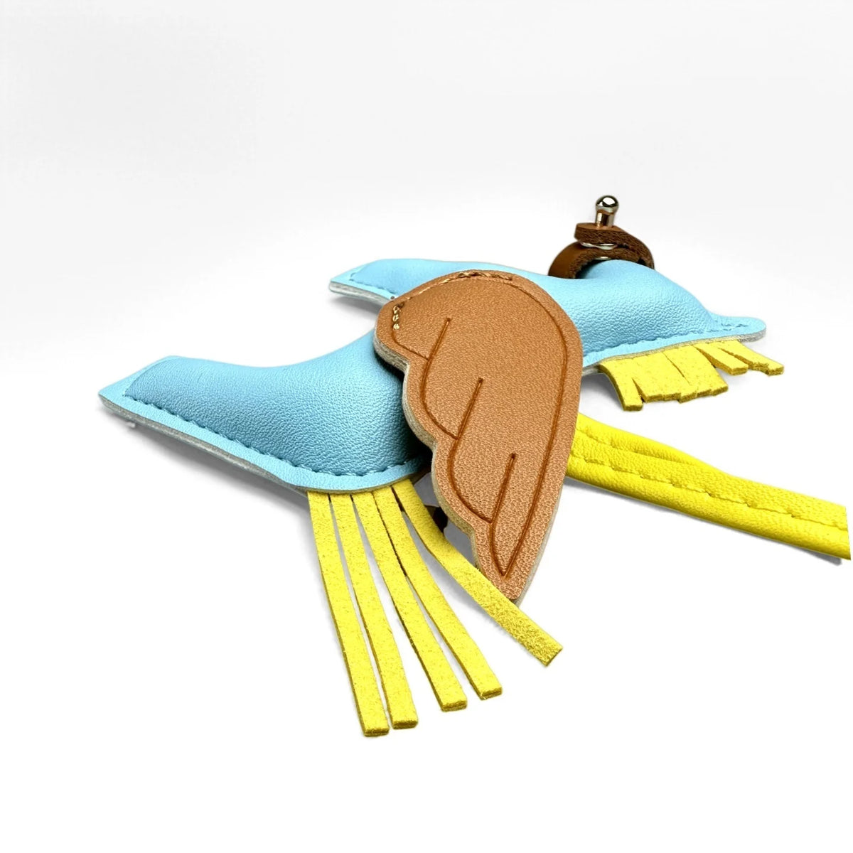 A keychain featuring an elegant winged pony design in light blue, brown, and yellow fabric.