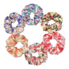 Un set de seis gomas de tela satinada con estampados florales en varios colores y patrones.