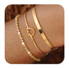 Three gold plated stainless steel bracelets worn on a person's wrist.