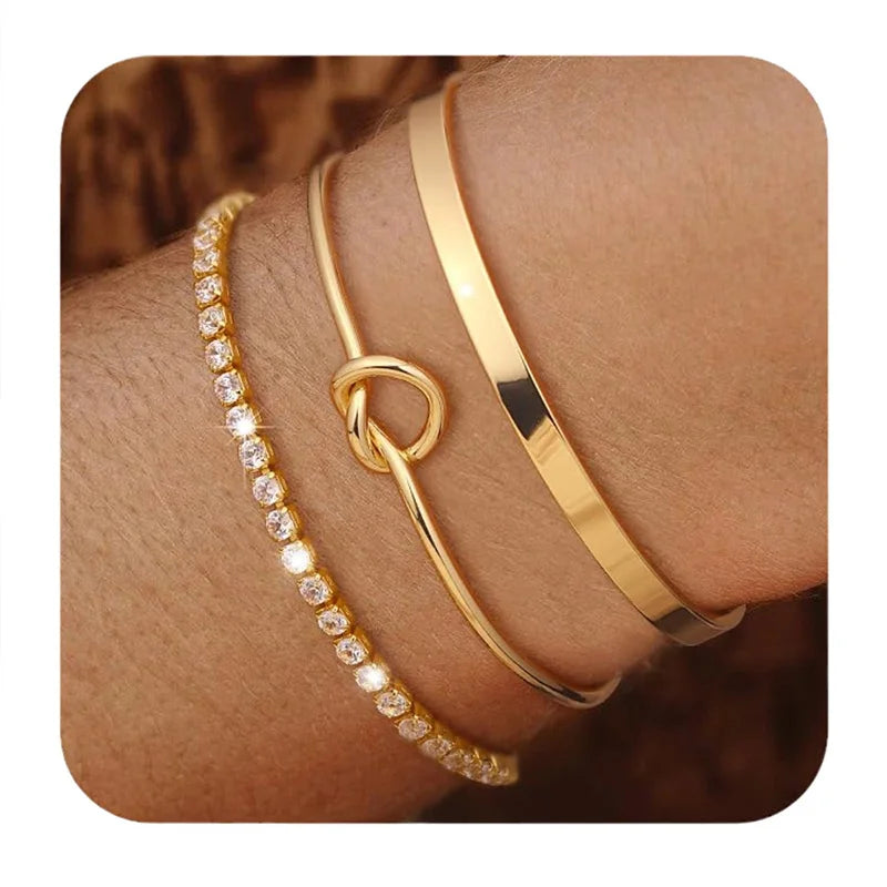 Three gold plated stainless steel bracelets worn on a person's wrist.
