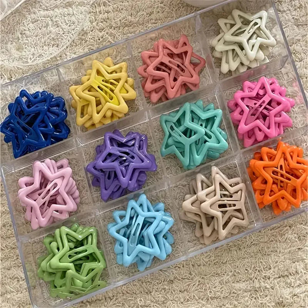 A collection of colorful retro star-shaped hair clips in various shades of pink, yellow, green, and purple arranged in a clea