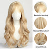 A long, wavy blonde wig displayed on a mannequin showing realistic hairline and smooth ends.