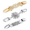 A set of vintage flower sweater clips in gold and silver metal.
