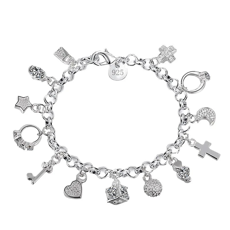 A silver geometric charm bracelet featuring various charms including a cross and heart shapes.