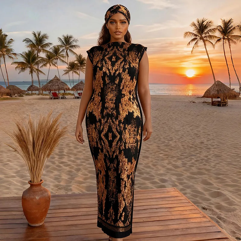 A plus size model wearing a black and gold African silk printed dress standing on a wooden deck near a beach at sunset.