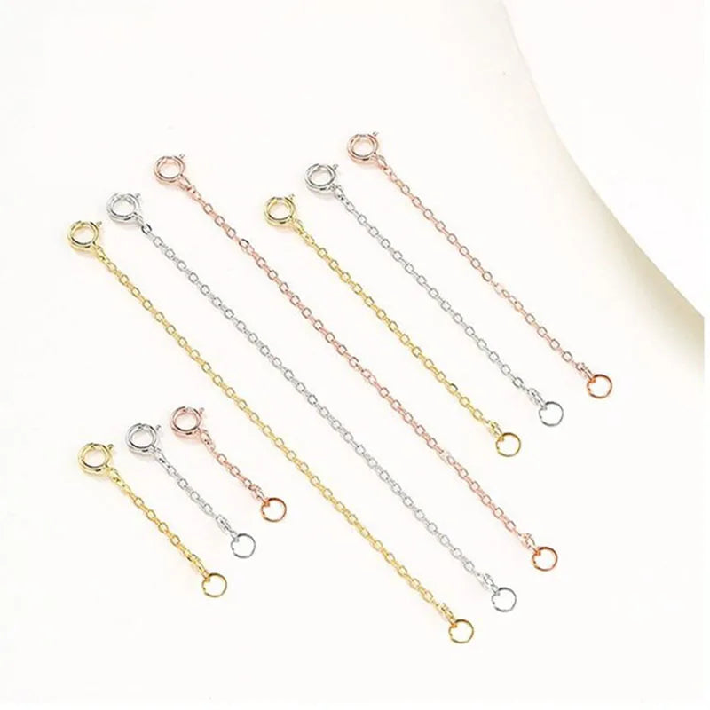 Multiple delicate 925 sterling silver extension chains for jewelry making displayed on a white background.