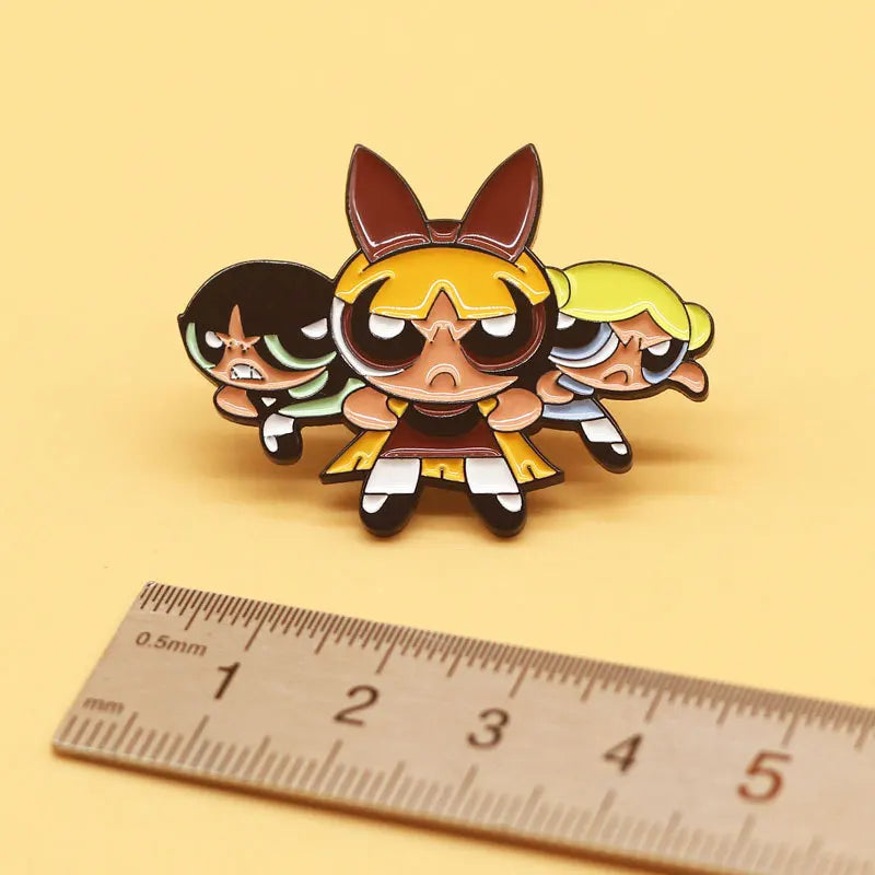 A set of five retro cartoon enamel lapel pins featuring stylized animal characters in various colors