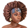 A model wears an extra large satin sleep bonnet with an elastic band in a rich brown color.