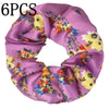 Un set de seis gomas de tela con estampado floral de satén en tonos morados y amarillos.