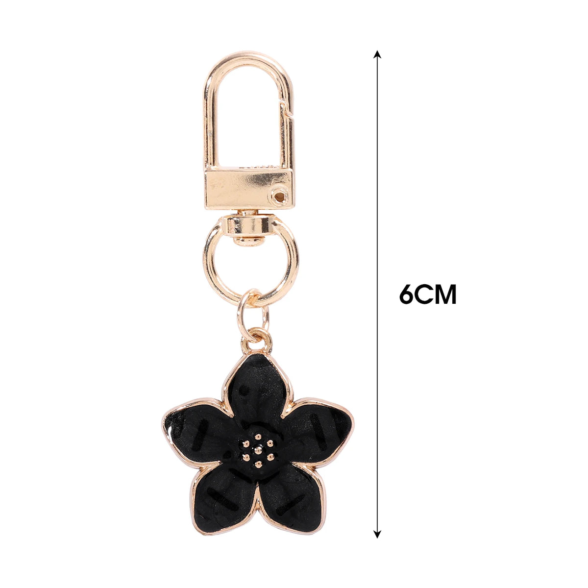 Llavero floral dorado con anillo y un dije de flor negra