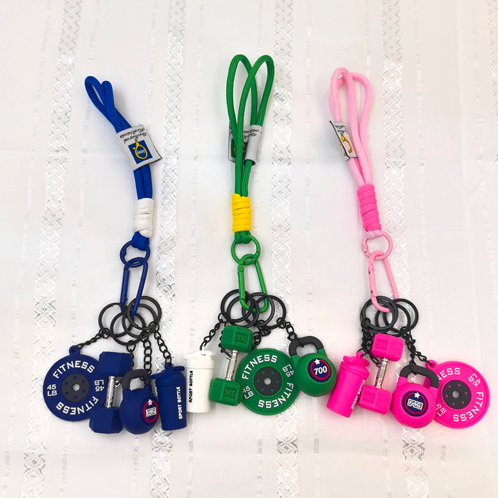 A collection of five colorful fitness keychains and weightlifting accessories featuring various colors like blue, green, and 