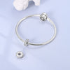 Sterling silver devil's eye charm bracelet with a silver clasp and a dangling charm