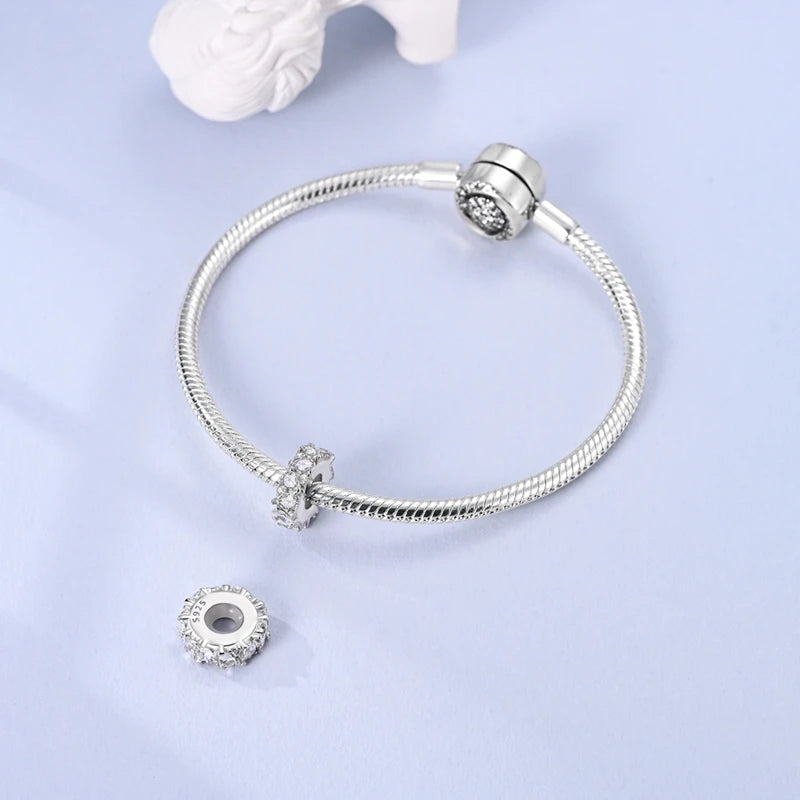 Sterling silver devil's eye charm bracelet with a silver clasp and a dangling charm