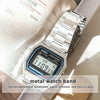 A close-up of a silver metal watch band with a digital watch featuring an alarm function.