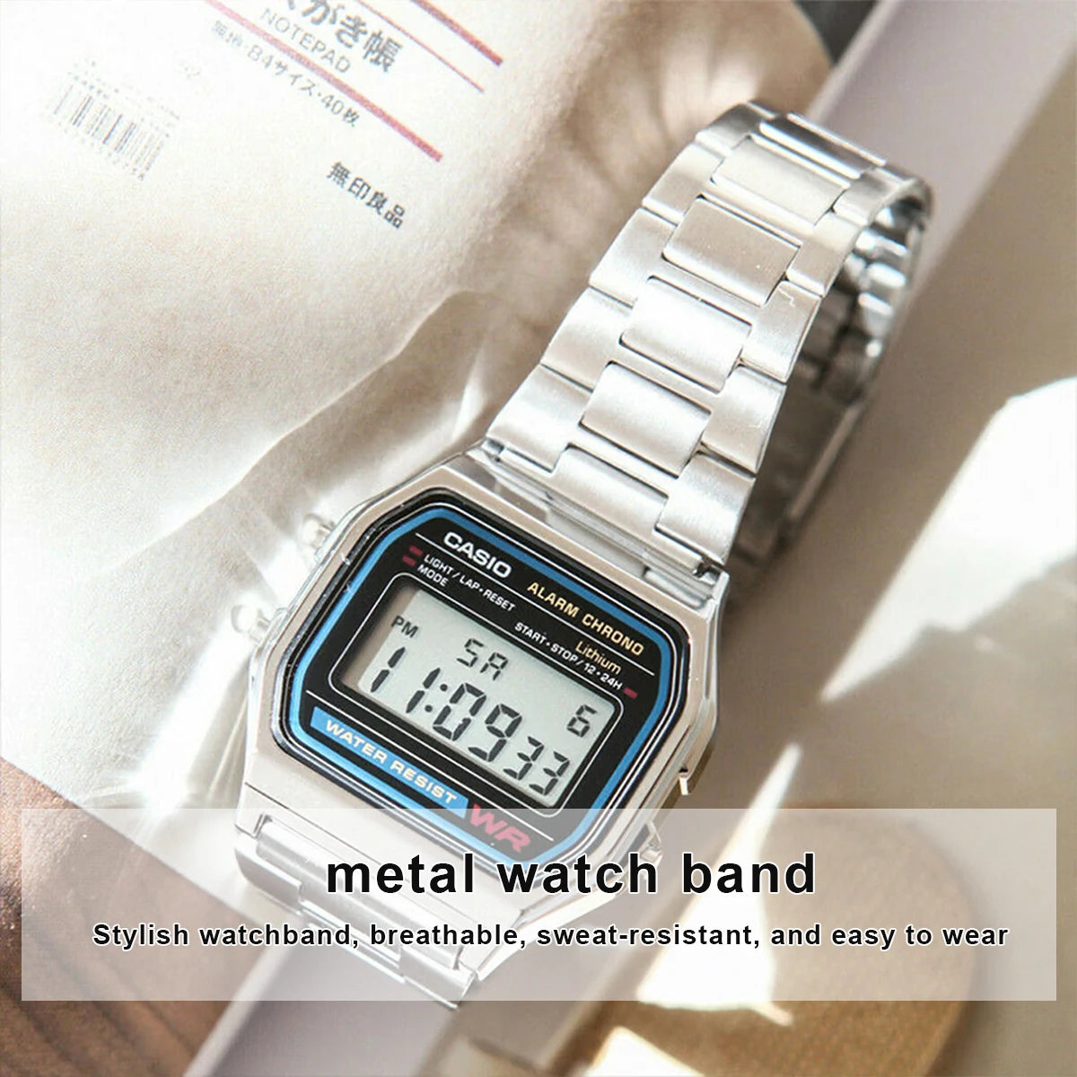 A close-up of a silver metal watch band with a digital watch featuring an alarm function.