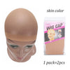 A beige wig cap is shown on a mannequin head, packaged for sale.