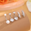A set of five gold stainless steel dangled belly button rings displayed on a neutral background.